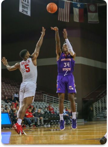 Houston Cougars guard Corey Davis Jr. (5) tries to block a shot by Northwestern State Demons forward Brandon Hutton (34)