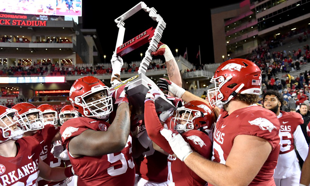 Arkansas Razorbacks lifting trophy