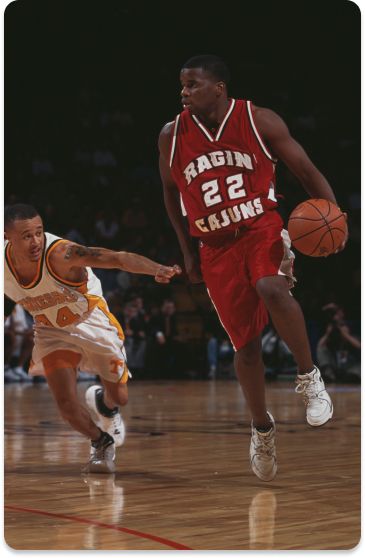 Blane Harmon #22, Guard for the Louisiana-Lafayette Ragin' Cajuns dribbles the ball