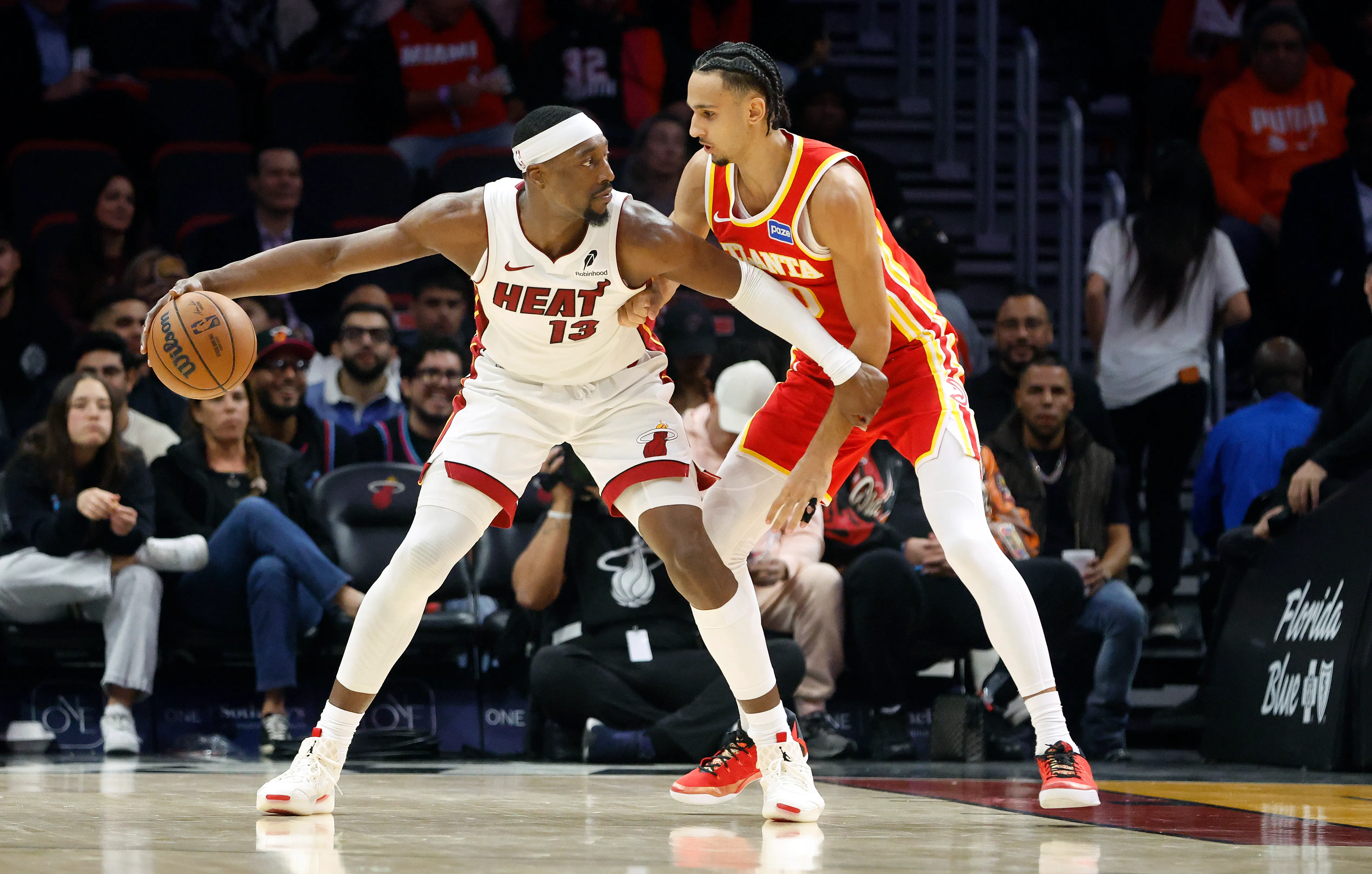 Atlanta Hawks forward Zaccharie Risacher (10) defends Miami Heat center Bam Adebayo (13). Credit: Rhona Wise-Imagn Images